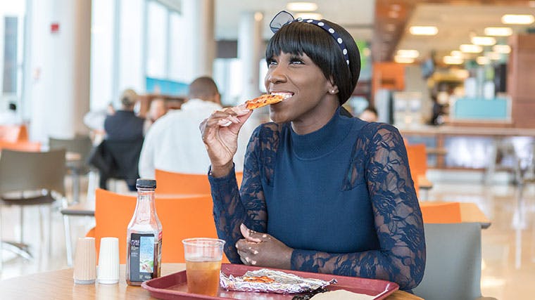 Dorian Brantley, University of Chicago patient and UChicago Medicine nurse, eating pizza again after her achalasia surgery