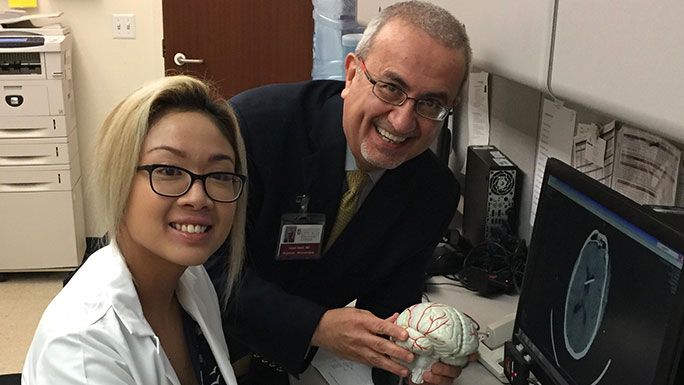 Neurosurgeon Issam Awad, MD, director of neurovascular surgery, and Kristina Piedad, RN.