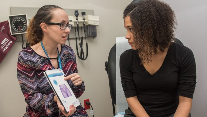Amber Truehart, MD, and female teen in clinic