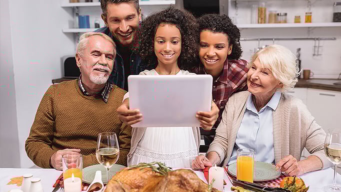 Family video chatting at holiday dinner