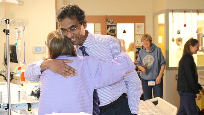 Triple organ transplant patient, Sarah McPharlin, hugs Dr. Valluvan Jeevanandam after transplant surgeries