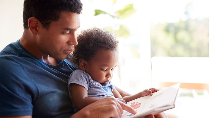 Father reading to a baby