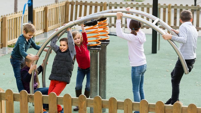 Kids playing on a jungle gym on a playground