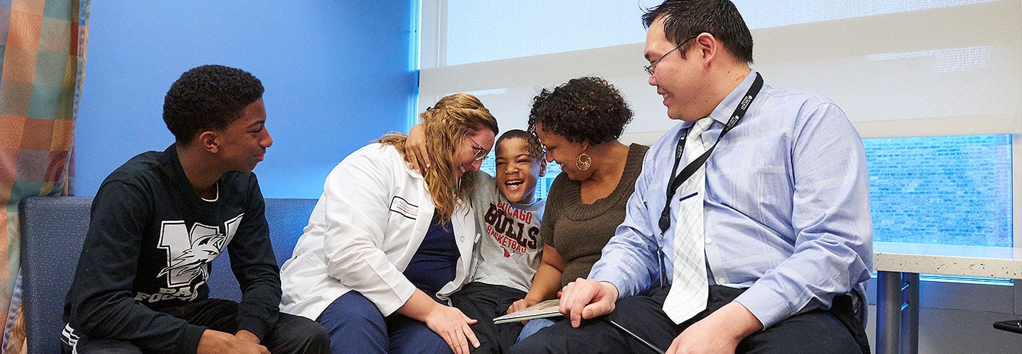 William Sterling, now seizure-free after starting a ketogenic diet, with his mom, brother, Dr. Chalongchai Phitsanuwong and nurse