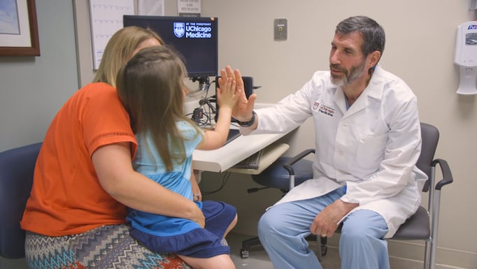 David From high fives a young patient