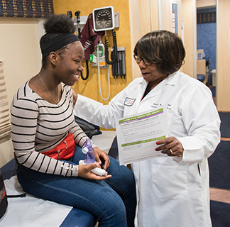 A young patient with a provider in the Comer pediatric mobile unit