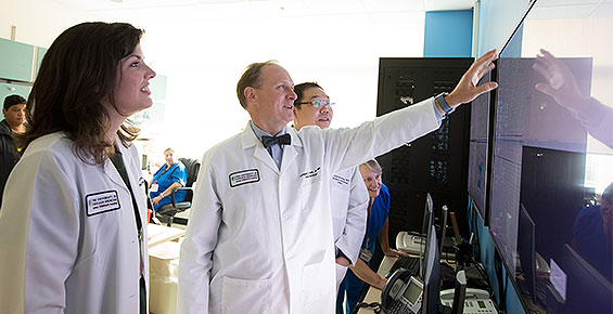 Pediatric neurologists Dr. Julia Henry, Dr. Douglas Nordli, Dr. Chalongchai Phitsanuwong reviewing data on a large screen