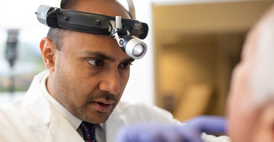 Nishant Agrawal, MD, examining patient