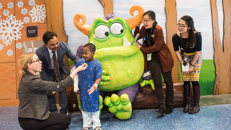 Dr. Gundeti, patient and team play bubbles with Remoc