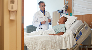 Dr. Russell Cohen talking with an IBD patient before surgery