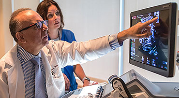 Fetal ultrasound expert Jacques Abramowicz, MD, pointing at an image on a screen