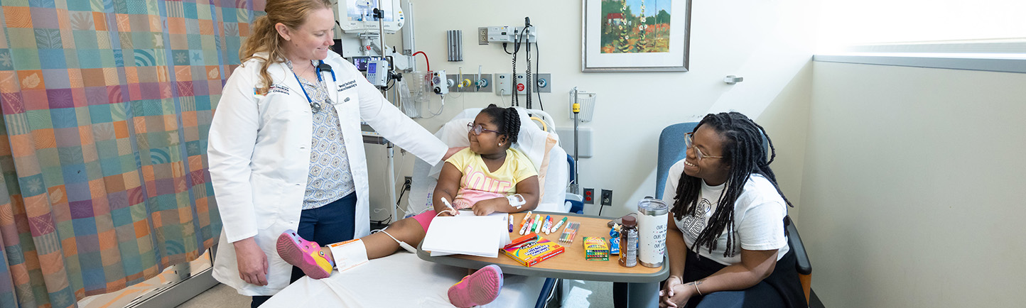 Patient Assata McPherson and her mother Jennifer Fikes get a visit from Dr. Wendy Darlington while receiving pediatric anemia treatment.