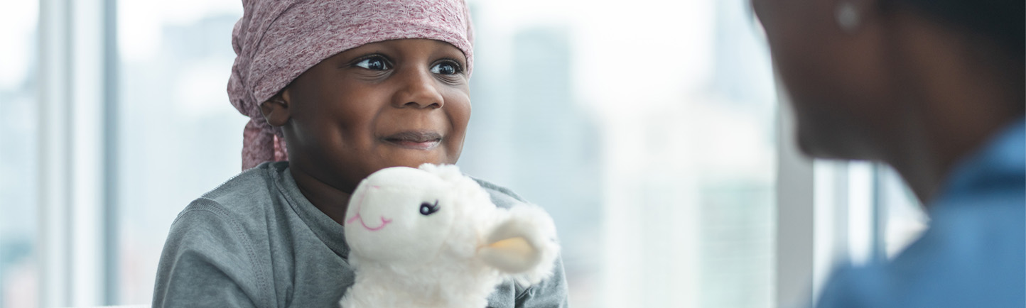 Image of pediatric cancer patient talking to nurse
