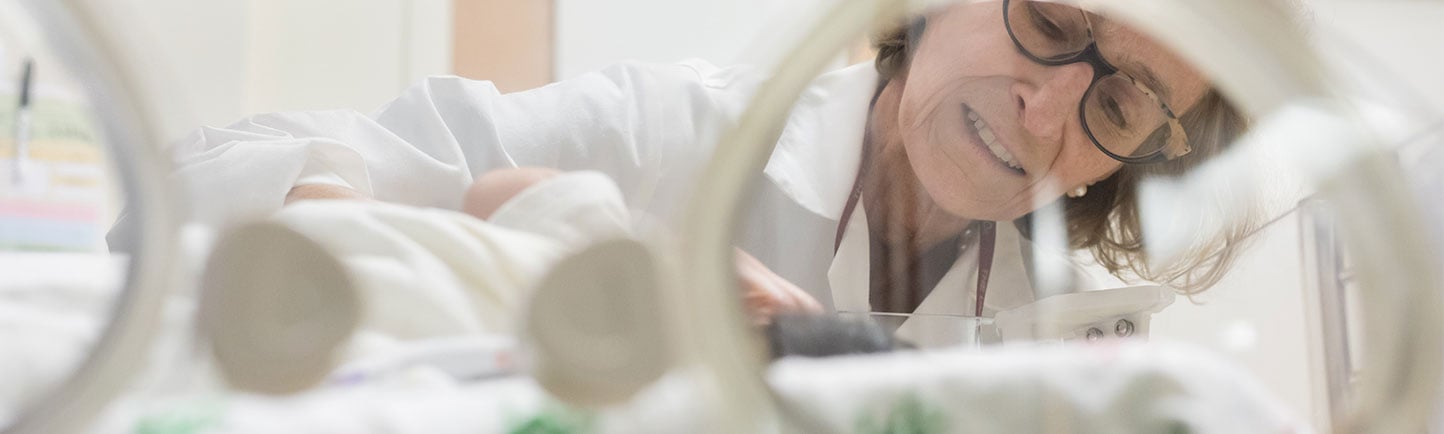 Dr. Kandel looking down at a patient