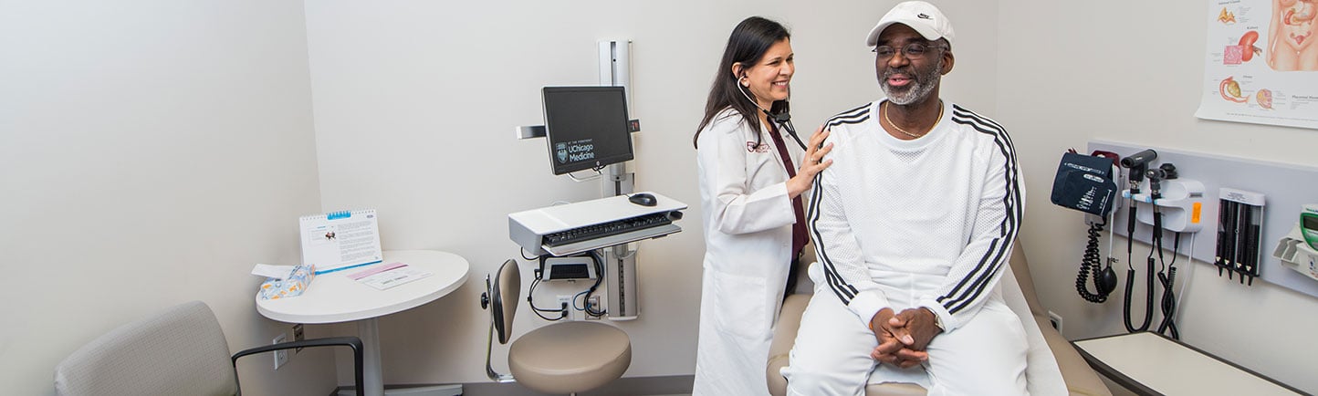 Dr. Hasan with diabetes patient in an exam room