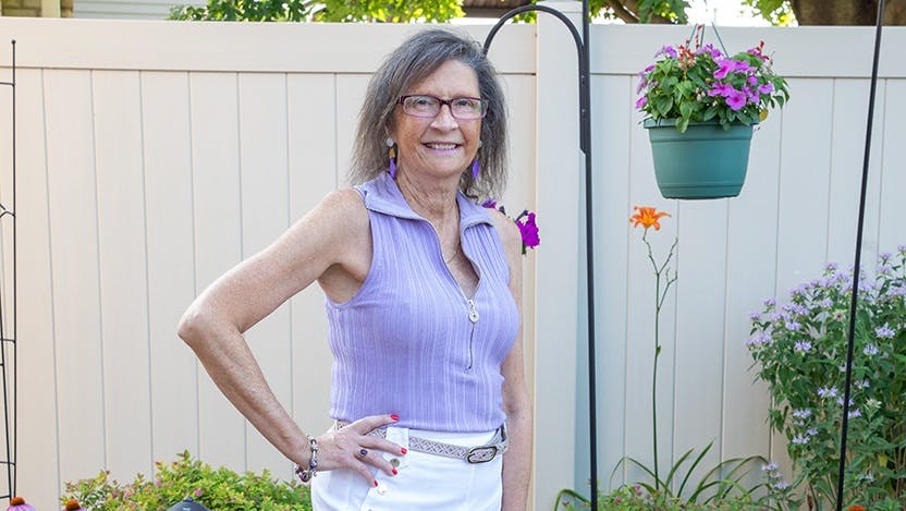 Female patient stands in garden