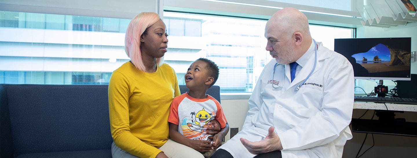 Image of Dr. Cunningham working with pediatric cancer patient