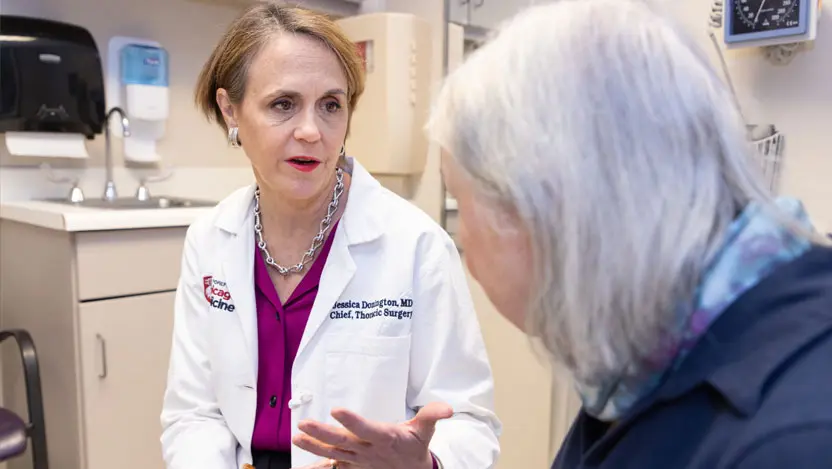 Thoracic surgeon Jessica Donington, MD, meets with a patient in clinic