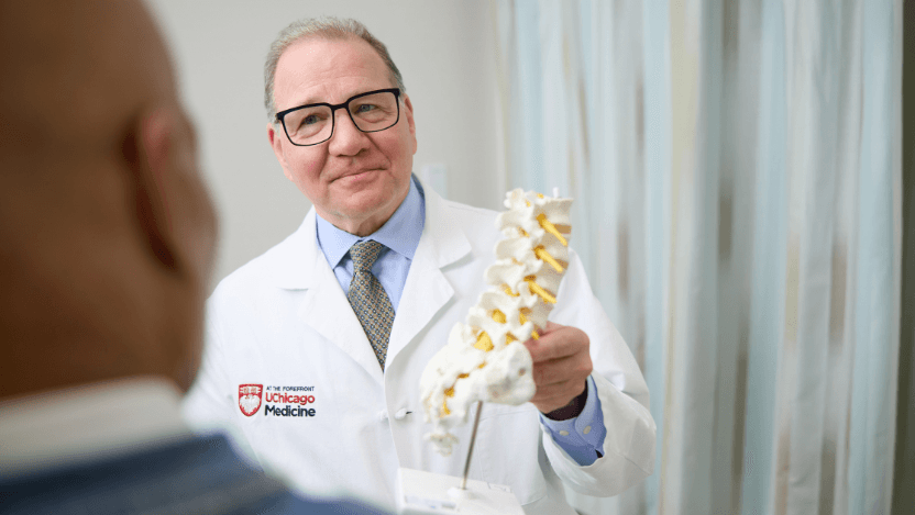Neurosurgeon Dr. Martin Herman explaining a model to a patient