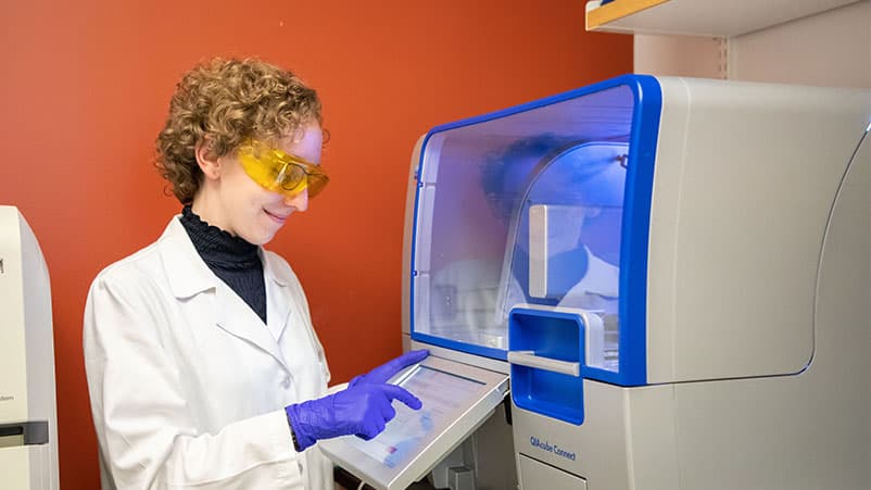Lab assistant working on machine