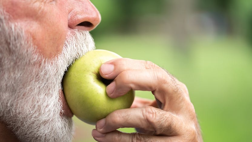 person biting into apple