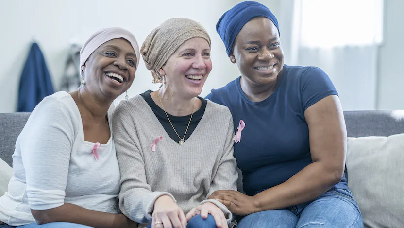 Photo of women wearing breast cancer awareness ribbon pins