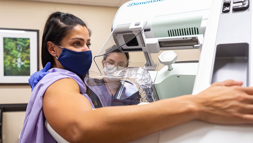 woman in mask receiving mammogram at UChicago Medicine River East Solis Mammography location
