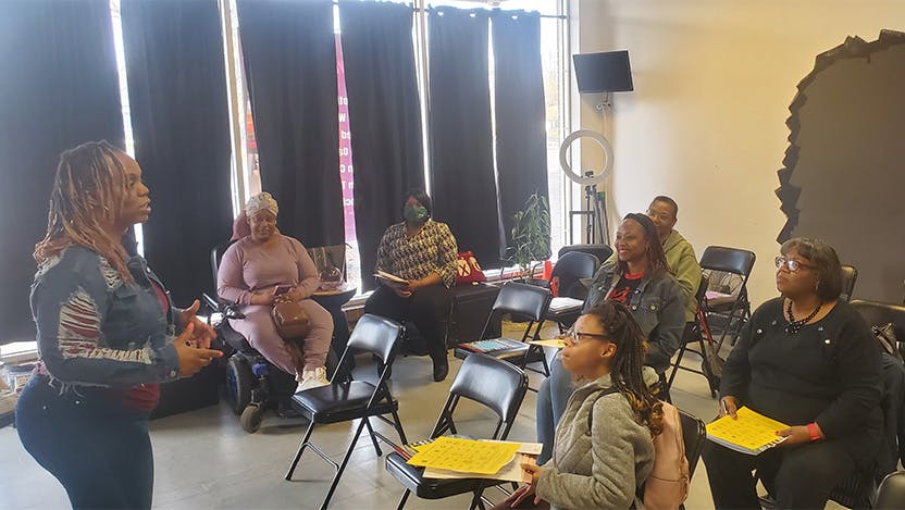 Myoshi Watts, owner of Armored Fitness and Nutrition, speaks with participants of the April Mental Wellbeing Spring Series session.