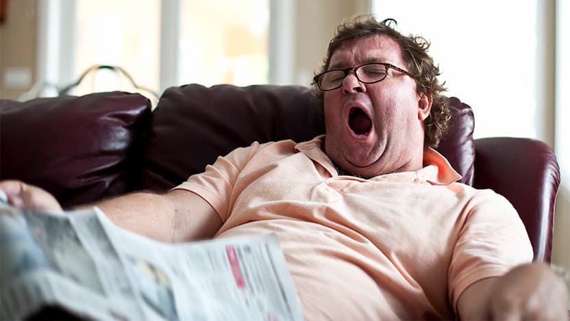 Man trying to nap on his couch