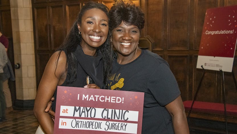 Two women post with a sign that says 'I matched!" at Mayo Clinic in Orthopedic Surgery