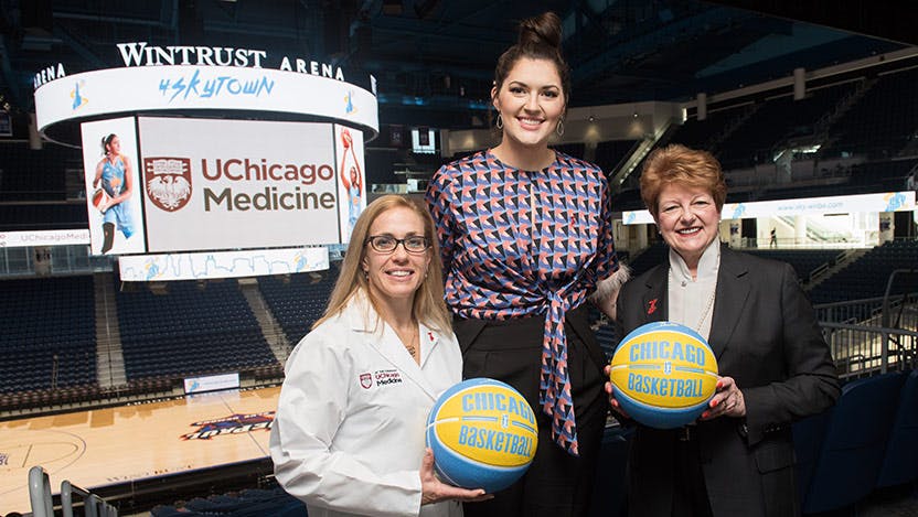 Dr. Benjamin, sports medicine specialist, Stephanie Dolson, Sky center, and Sharon O'Keefe, then-President of the University of Chicago Medical Center, celebrate the new partnership.