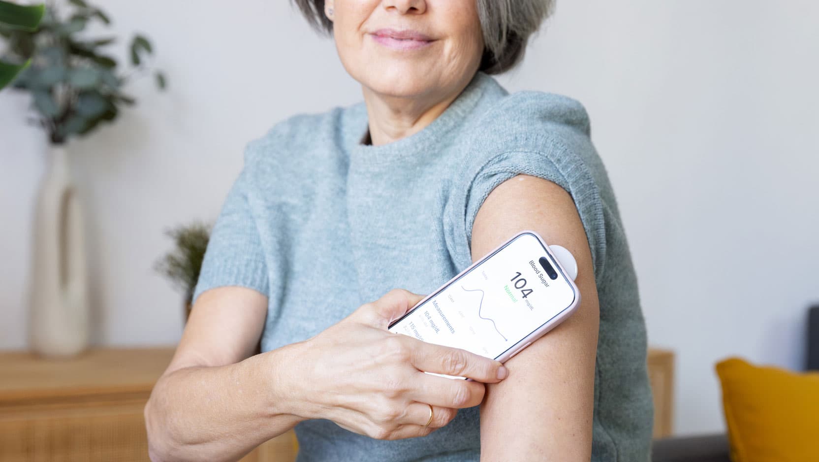 Woman testing blood surgery using a continuous glucose monitor
