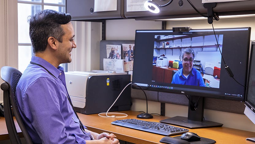 Sachin D. Shah, MD, conducts a telemedicine visit with Camilo Garza as he recovers from an injury.