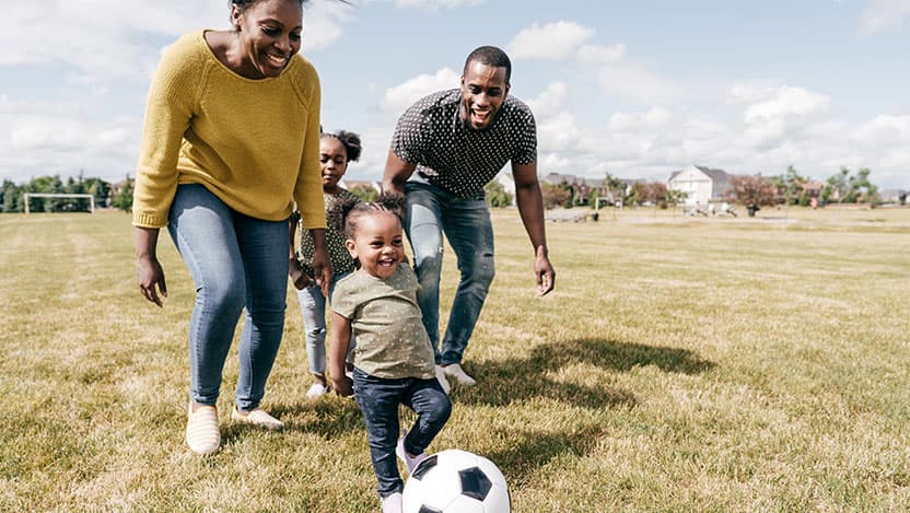 Parents and kids playing soccer