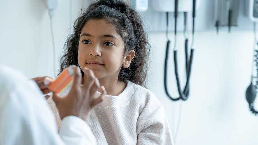 Image of doctor talking to a pediatric patient about asthma