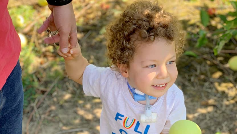 Smiling young patient with tracheostomy tube