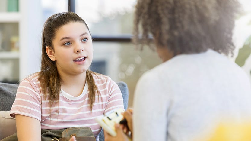 A teen talking with a transition clinic provider