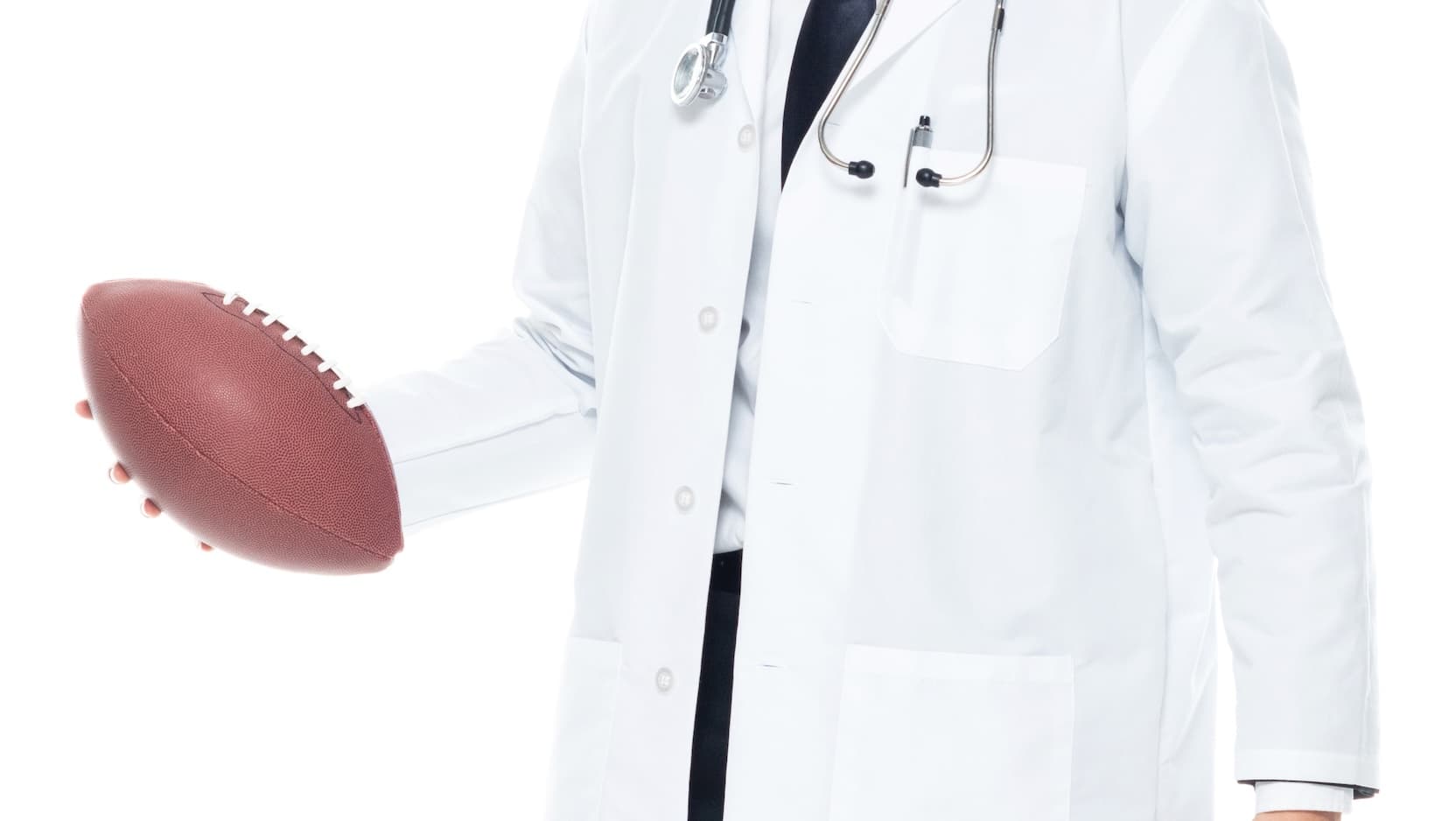 Physician in white coat holding a football