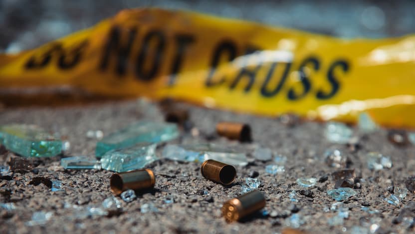 Bullet casings and police tape on ground