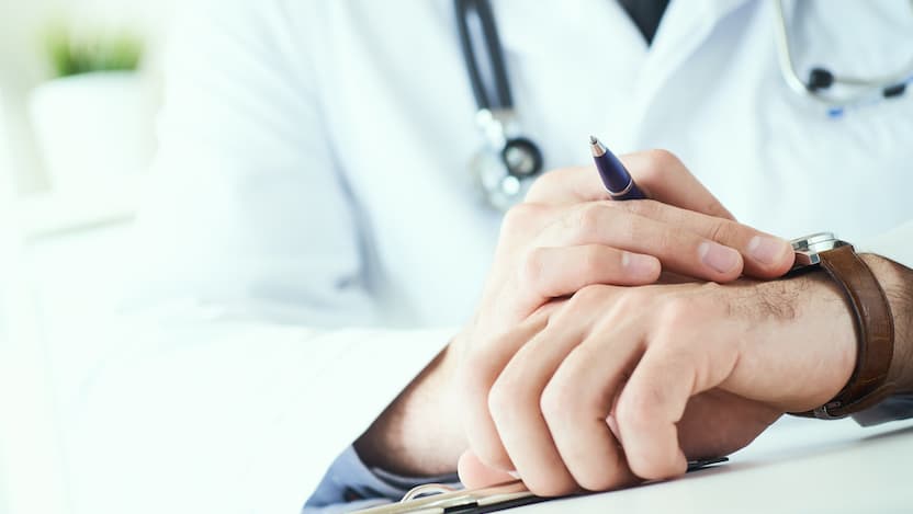 doctor touching watch