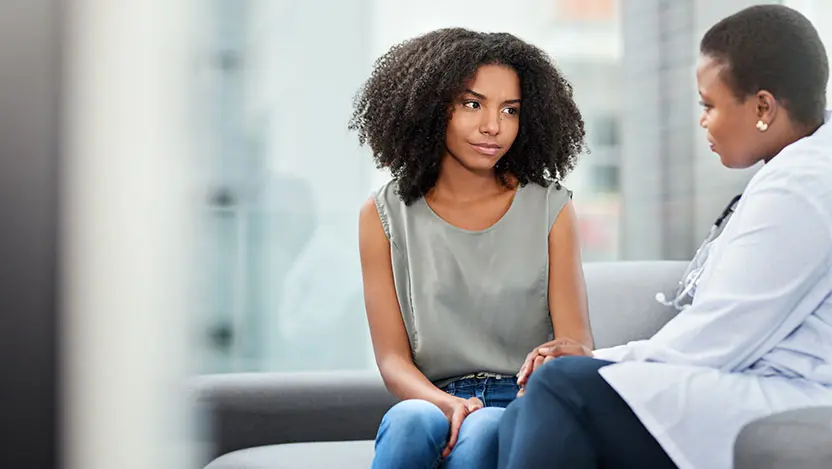 Patient having serious talk with gynecologist