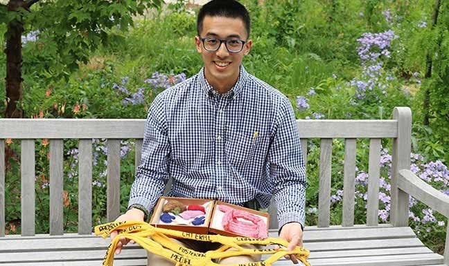 Pritzker student Daniel Lam with a knitting project
