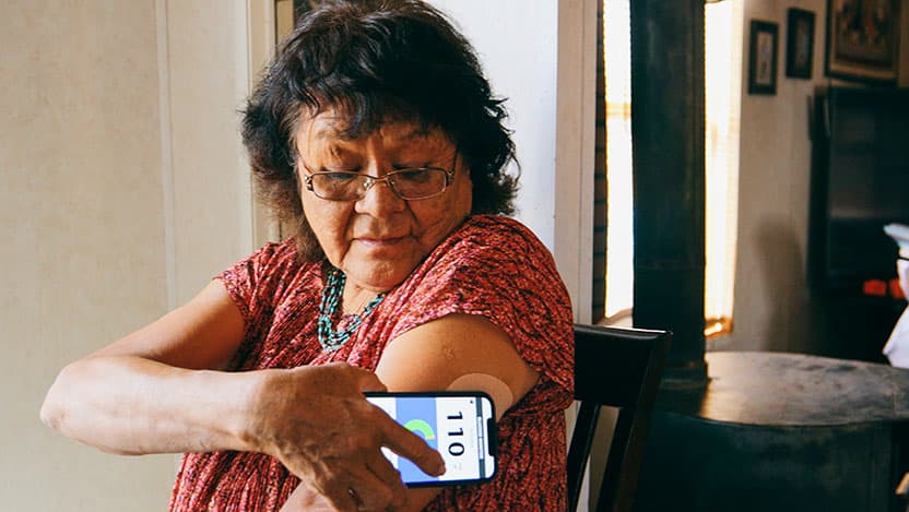 A woman checks her insulin levels with a digital tool