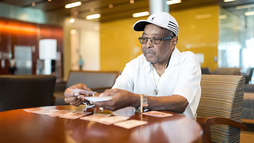 Morris Fourte, a retired machine repairman, is engaged in one of his favorite pastimes—playing cards. Fourte’s life was saved when Dr. Uzma Siddiqui performed a complex endoscopic procedure.