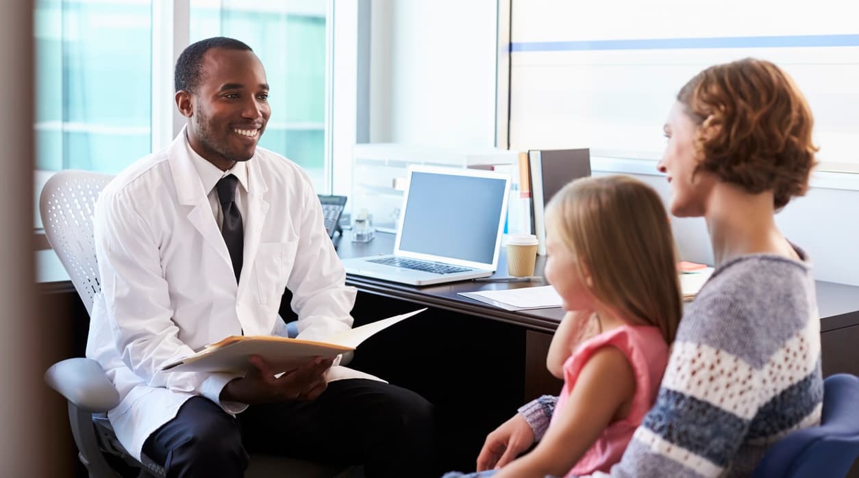 Pediatrician Meeting With Mother And Child In Hospital