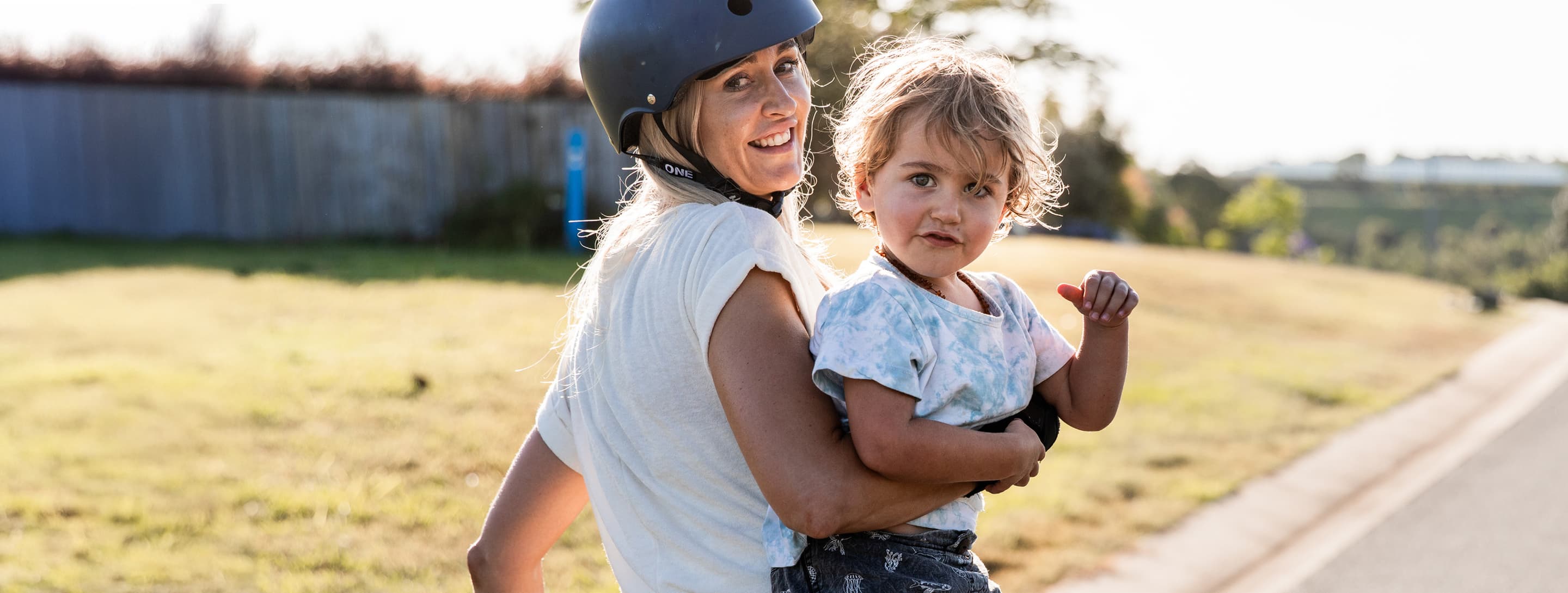 Mother in bike helmet with child in arms