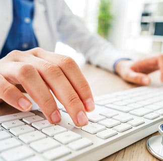 doctor typing on keyboard