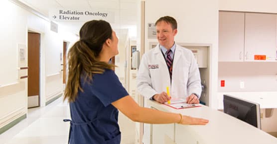 Steven J. Chmura, MD, PhD, and colleague in clinic