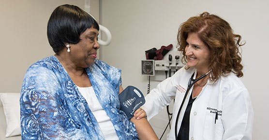 Dr. Silvana Pannain, endocrinologist and leader of Chicago Weight, reading a patient's blood pressure