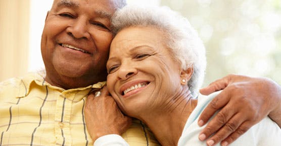 African-American elderly couple embracing
